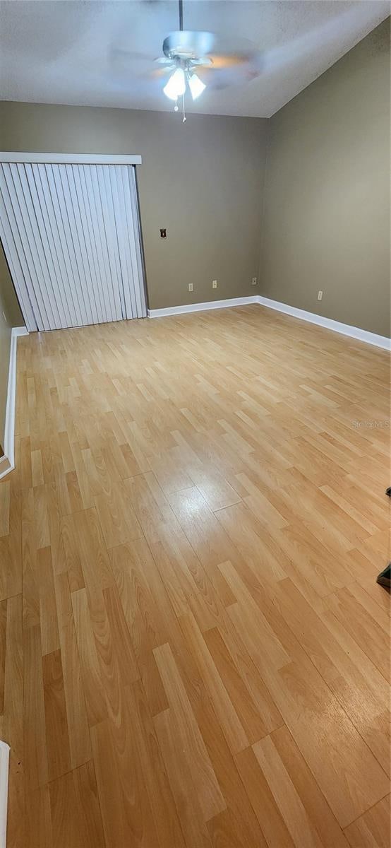 empty room featuring ceiling fan and light wood-type flooring