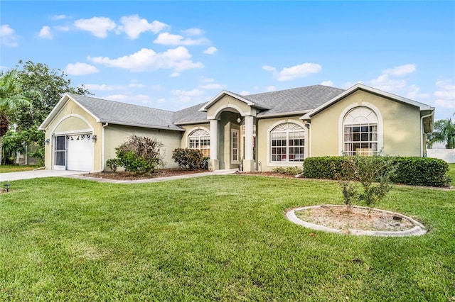 ranch-style house featuring a garage and a front yard