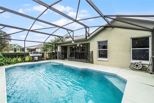 view of swimming pool featuring ceiling fan, a grill, a patio, and glass enclosure