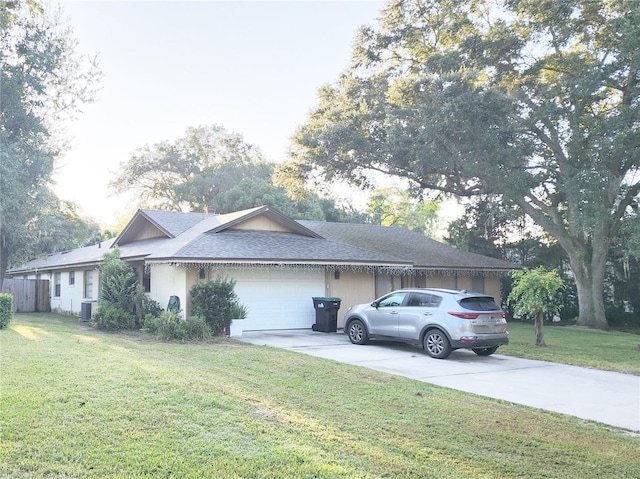 single story home featuring a garage, cooling unit, and a front lawn