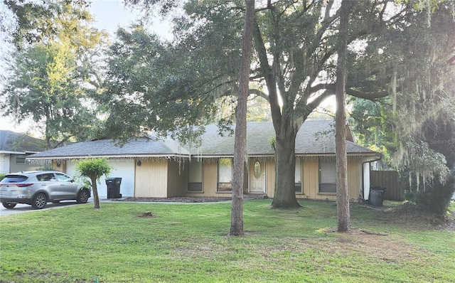 single story home with a front yard and a garage