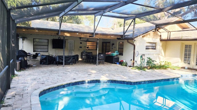 view of swimming pool with a lanai and a patio area