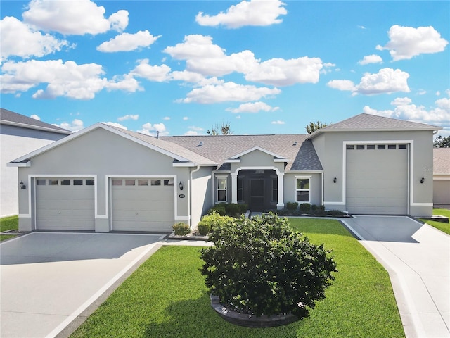 ranch-style home with a garage and a front lawn