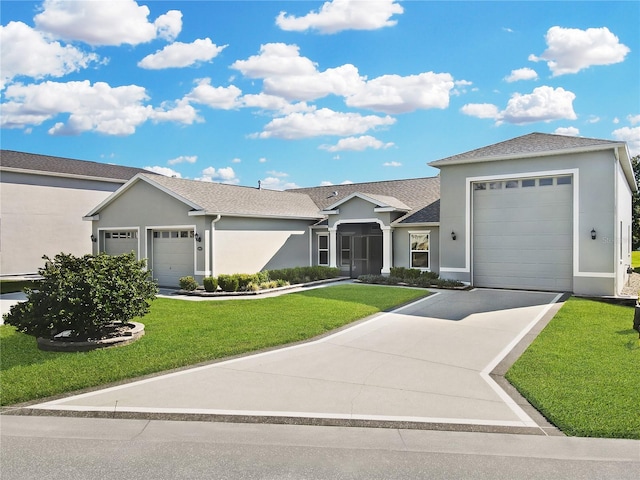 single story home with a garage and a front lawn