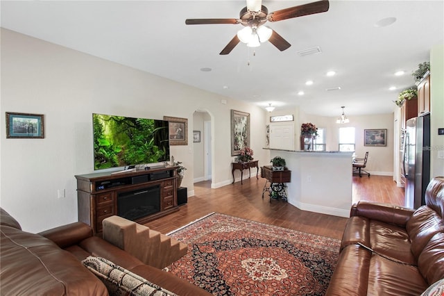 living room featuring wood-type flooring and ceiling fan