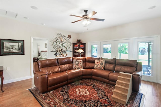 living room featuring light hardwood / wood-style floors and ceiling fan