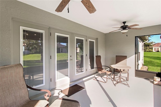 sunroom / solarium with ceiling fan and french doors