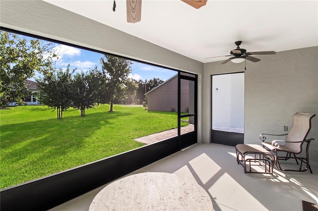 sunroom / solarium featuring ceiling fan