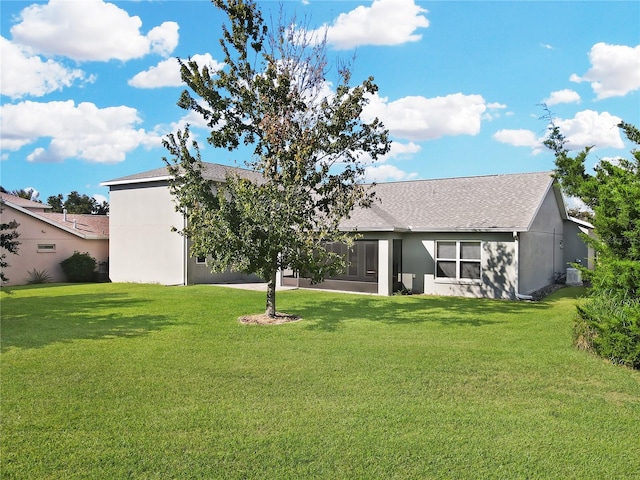 back of house with a lawn