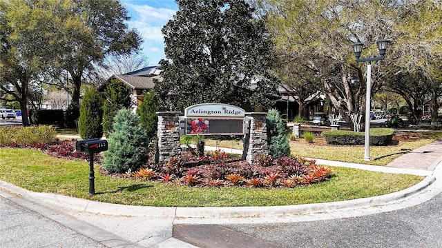 community sign featuring a lawn