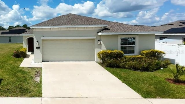 single story home with a front yard and a garage