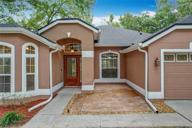 view of exterior entry with a garage