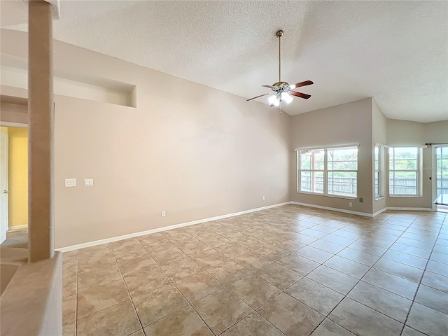 unfurnished room featuring a textured ceiling, light tile patterned floors, and ceiling fan