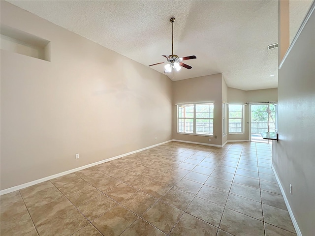 tiled empty room featuring a textured ceiling and ceiling fan