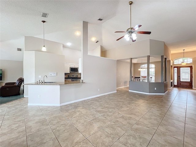 kitchen featuring kitchen peninsula, white cabinetry, stainless steel appliances, pendant lighting, and high vaulted ceiling