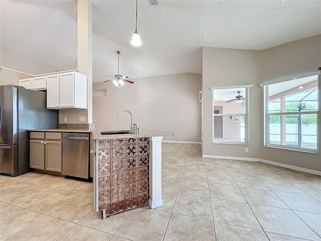 kitchen featuring appliances with stainless steel finishes, sink, white cabinets, high vaulted ceiling, and light tile patterned floors