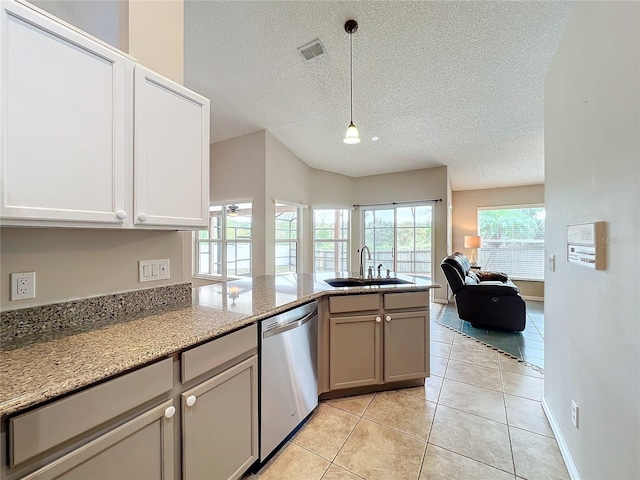 kitchen with stainless steel dishwasher, light stone counters, sink, and hanging light fixtures