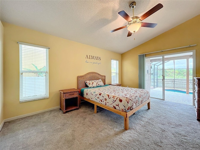 carpeted bedroom featuring multiple windows, access to exterior, lofted ceiling, and ceiling fan