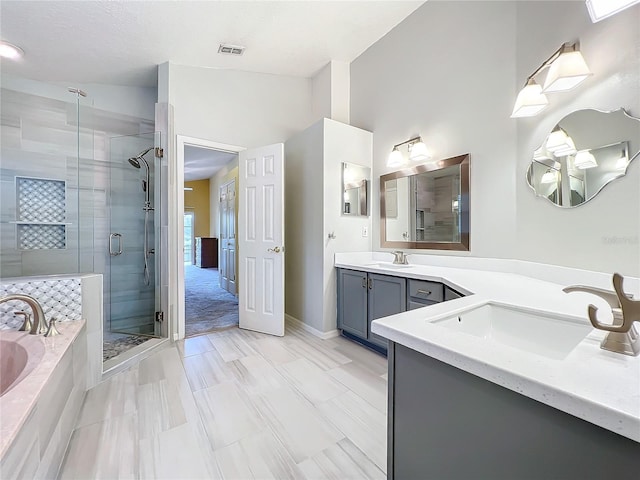 bathroom featuring vanity and separate shower and tub