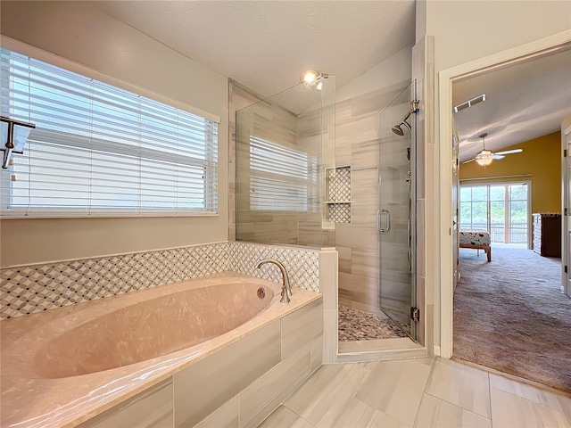 bathroom with shower with separate bathtub, a textured ceiling, ceiling fan, tile patterned floors, and lofted ceiling