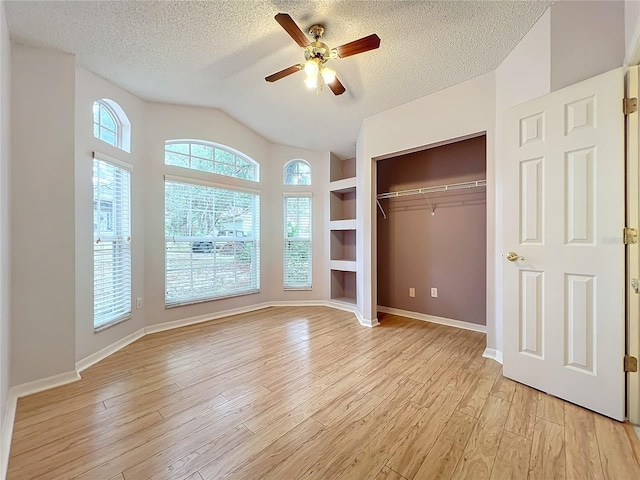 unfurnished bedroom with light hardwood / wood-style flooring, a textured ceiling, a closet, and ceiling fan