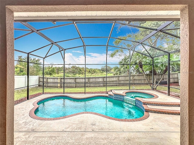 view of pool with an in ground hot tub, a patio, and glass enclosure