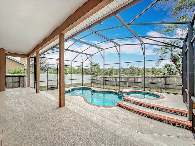 view of swimming pool with a patio area, an in ground hot tub, and glass enclosure