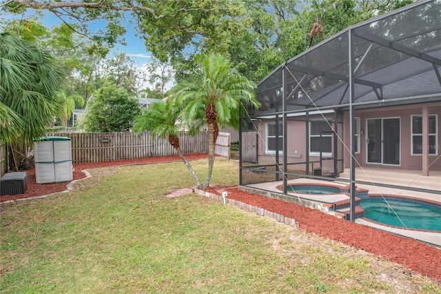 view of yard featuring a pool with hot tub, a patio area, and glass enclosure