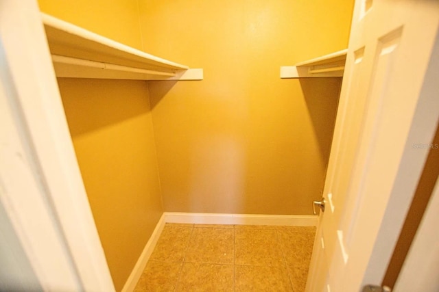 walk in closet featuring tile patterned flooring