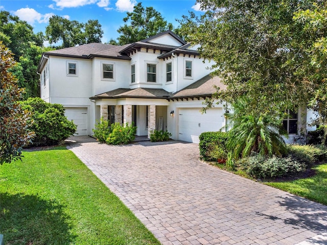 view of front of house with a front yard and a garage