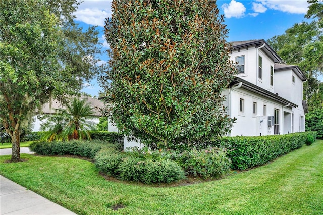 view of side of home with a lawn