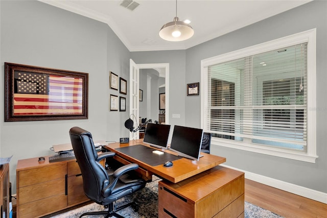 office area featuring light hardwood / wood-style flooring and ornamental molding