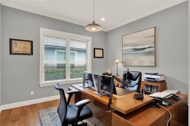 office space featuring light hardwood / wood-style floors, plenty of natural light, and crown molding