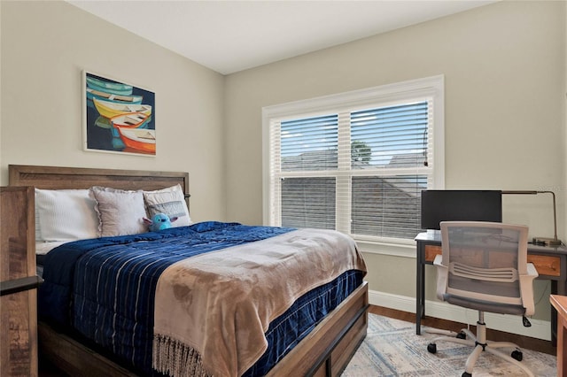 bedroom with hardwood / wood-style flooring