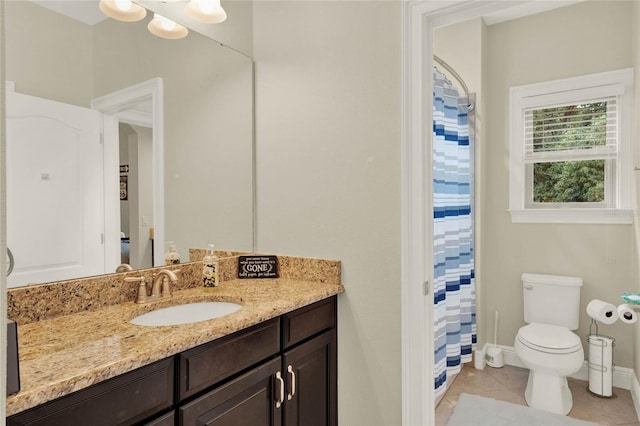 bathroom featuring a shower with curtain, vanity, tile patterned flooring, and toilet