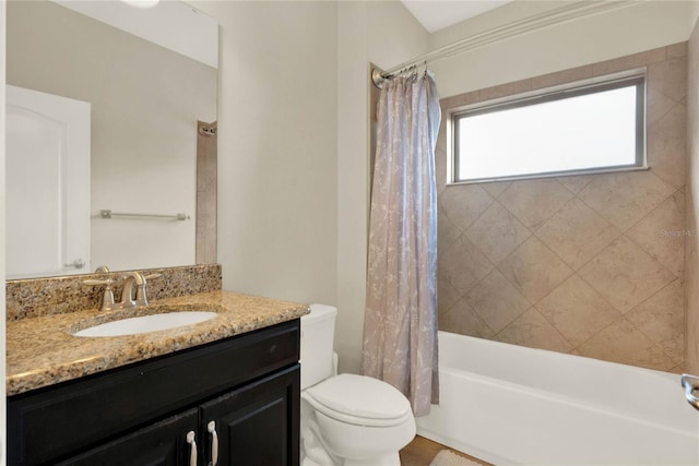 full bathroom featuring vanity, shower / tub combo, and toilet