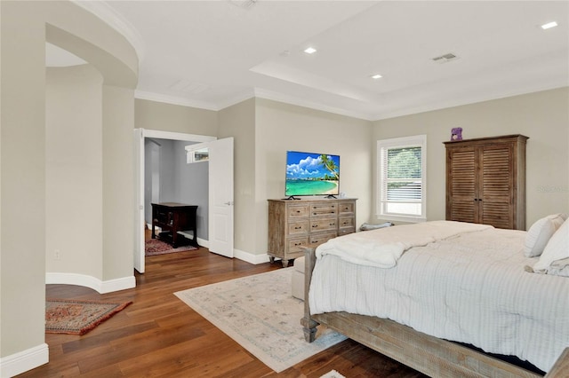 bedroom with ornamental molding and dark wood-type flooring