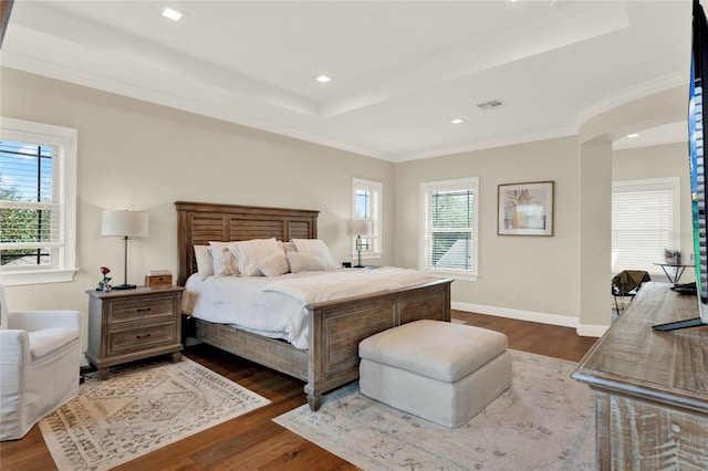 bedroom with multiple windows, crown molding, and dark wood-type flooring