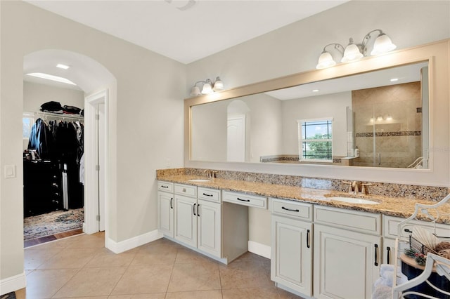 bathroom featuring tile patterned floors, vanity, and tiled shower