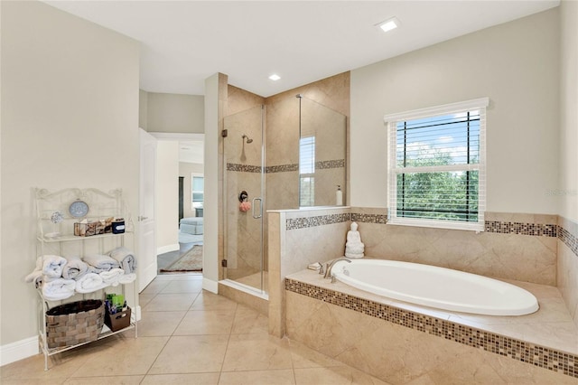 bathroom featuring plus walk in shower and tile patterned flooring