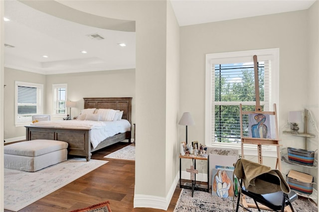 bedroom with multiple windows and dark wood-type flooring