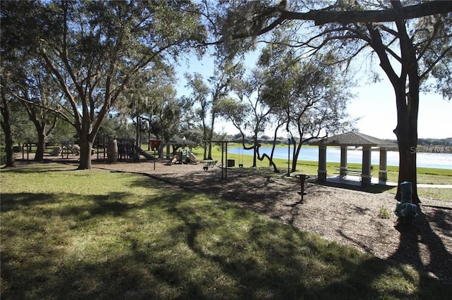 surrounding community with a playground, a gazebo, a water view, and a yard