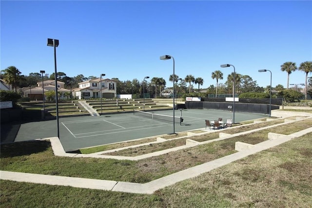 view of sport court featuring a lawn