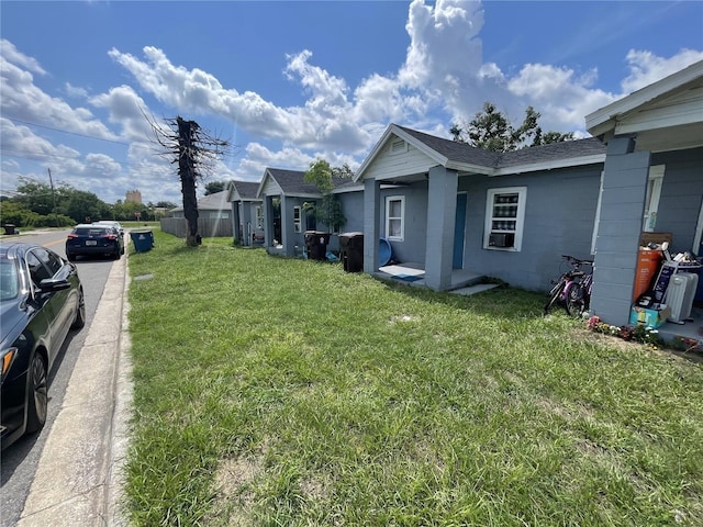 236 Washington Ave, Lake Wales, FL 33853 - view of home's exterior featuring roof with shingles, concrete block siding, and a lawn