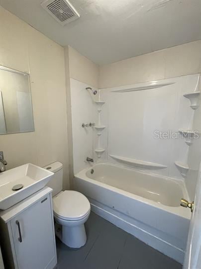 full bathroom featuring tile patterned flooring, shower / bath combination, vanity, and toilet
