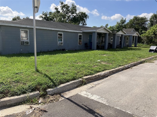view of front of property with cooling unit and a front lawn