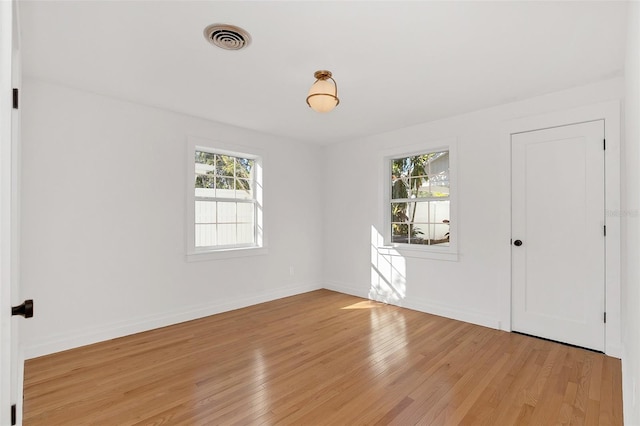 spare room with light hardwood / wood-style flooring