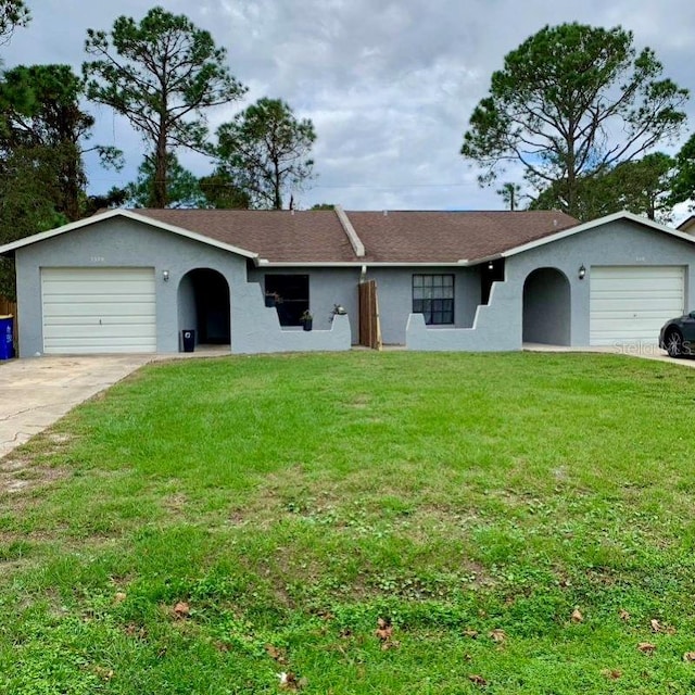 ranch-style house featuring a front yard and a garage