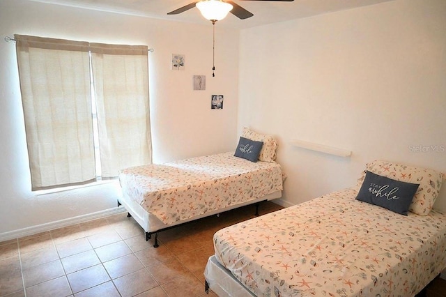 tiled bedroom with ceiling fan