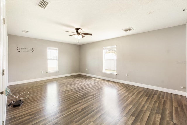 unfurnished room with ceiling fan and dark hardwood / wood-style floors